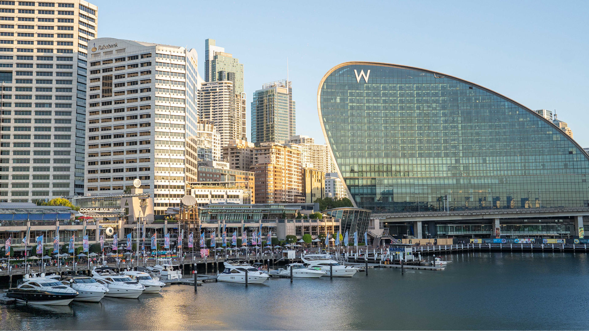 Panoramic view of Darling Harbour waterfront with city skyline and boats